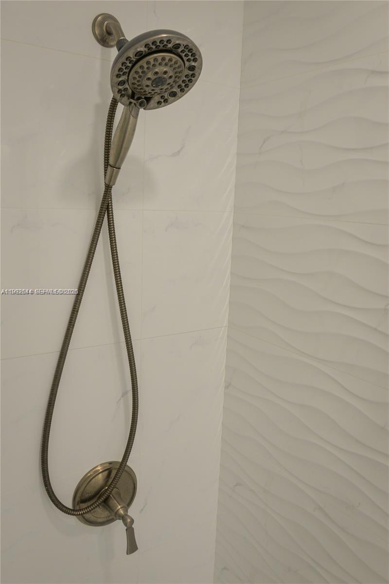 7849 Southwest 103rd Place Miami, FL 33173 - Photo 33 of 64 a bathroom with a shower
