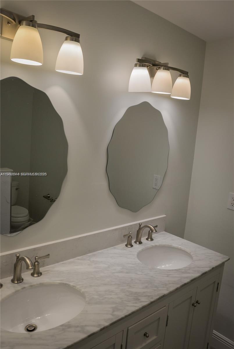7849 Southwest 103rd Place Miami, FL 33173 - Photo 35 of 64 a bathroom with a sink and a mirror