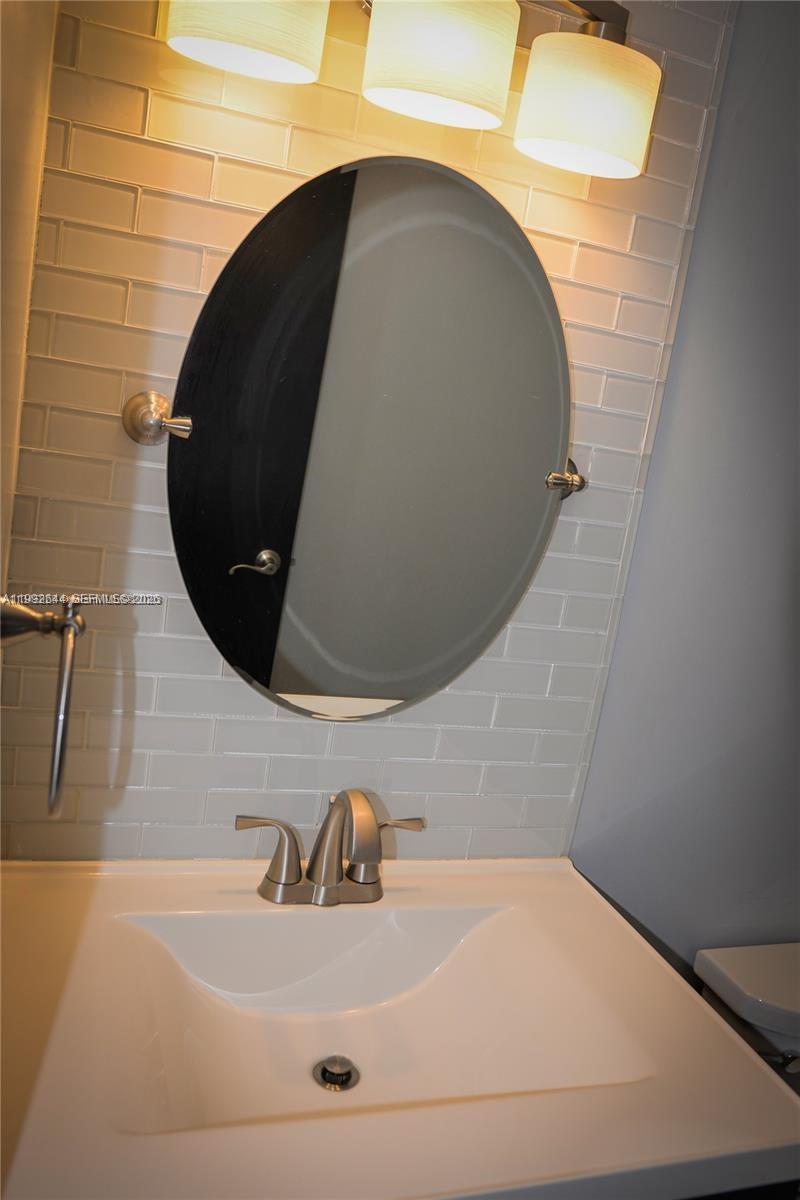7849 Southwest 103rd Place Miami, FL 33173 - Photo 45 of 64 a bathroom with a sink and a mirror