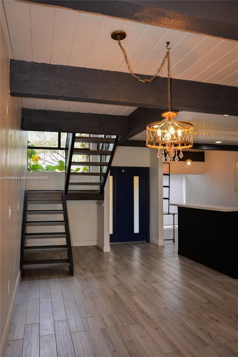 7849 Southwest 103rd Place Miami, FL 33173 - Photo 5 of 64 a view of a room with wooden floor and a ceiling fan