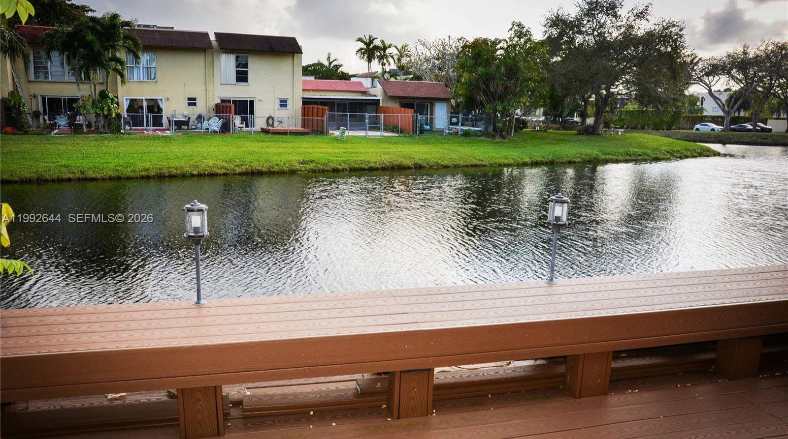 7849 Southwest 103rd Place Miami, FL 33173 - Photo 54 of 64 a view of a lake with a house in the background