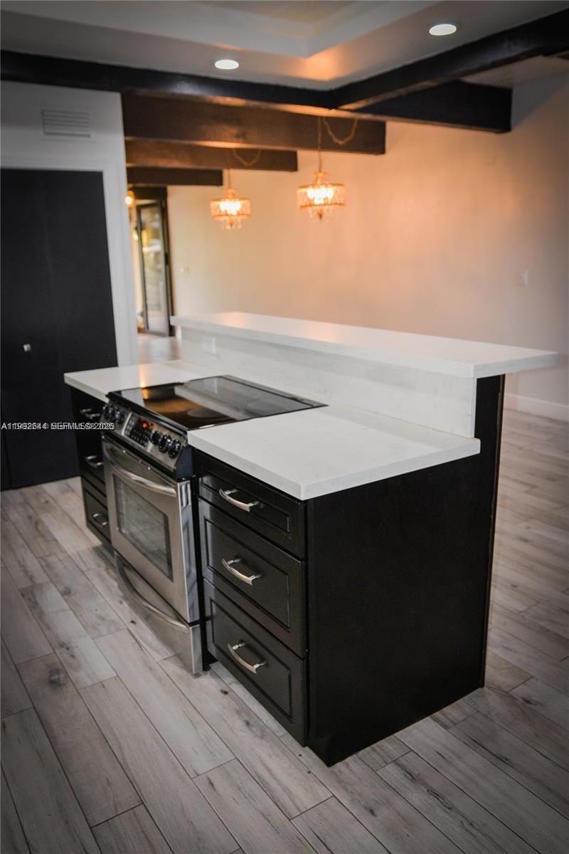 7849 Southwest 103rd Place Miami, FL 33173 - Photo 8 of 64 a kitchen with a stove and a wooden floor