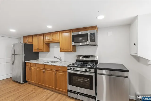 a kitchen with stainless steel appliances a refrigerator stove and microwave