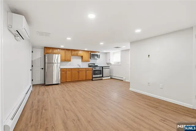 a view of a kitchen with a sink and a refrigerator