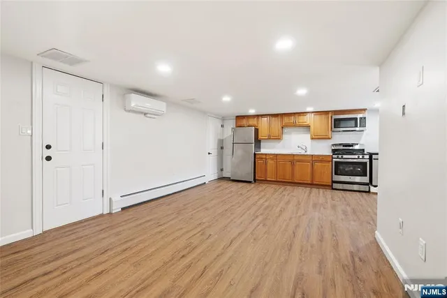 a view of a kitchen with wooden floor