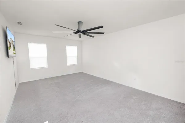 a bathroom with a granite countertop sink a mirror and a bathtub
