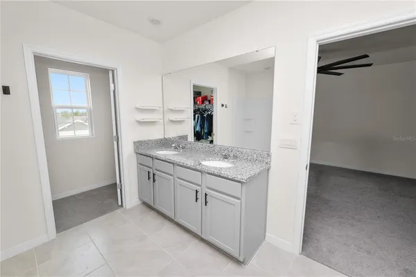 a large bed sitting in a bedroom next to a window