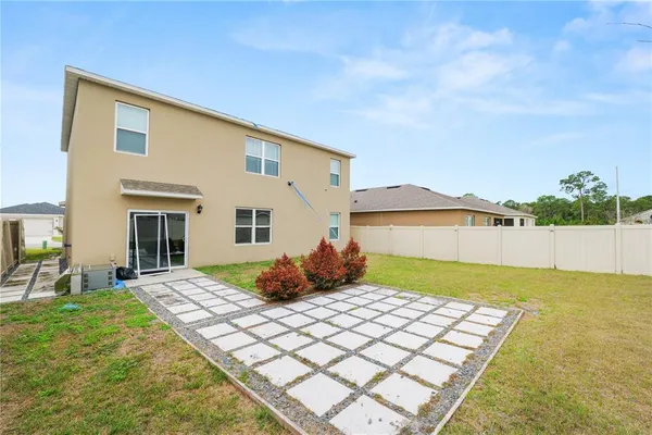 a view of a house with swimming pool and a yard