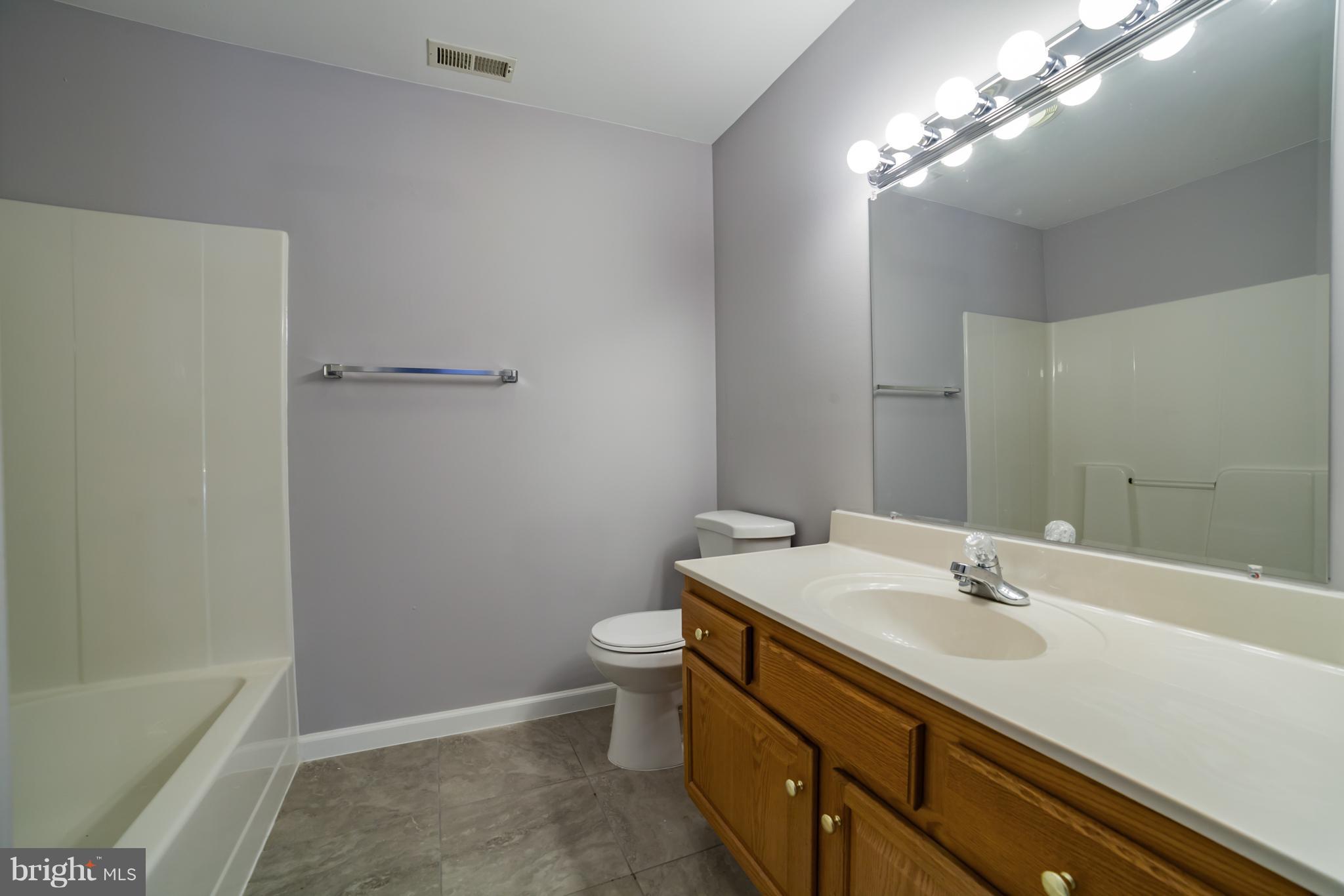 320 W Road Baltimore, MD 21221 - Photo 20 of 30 a bathroom with a sink a toilet and shower