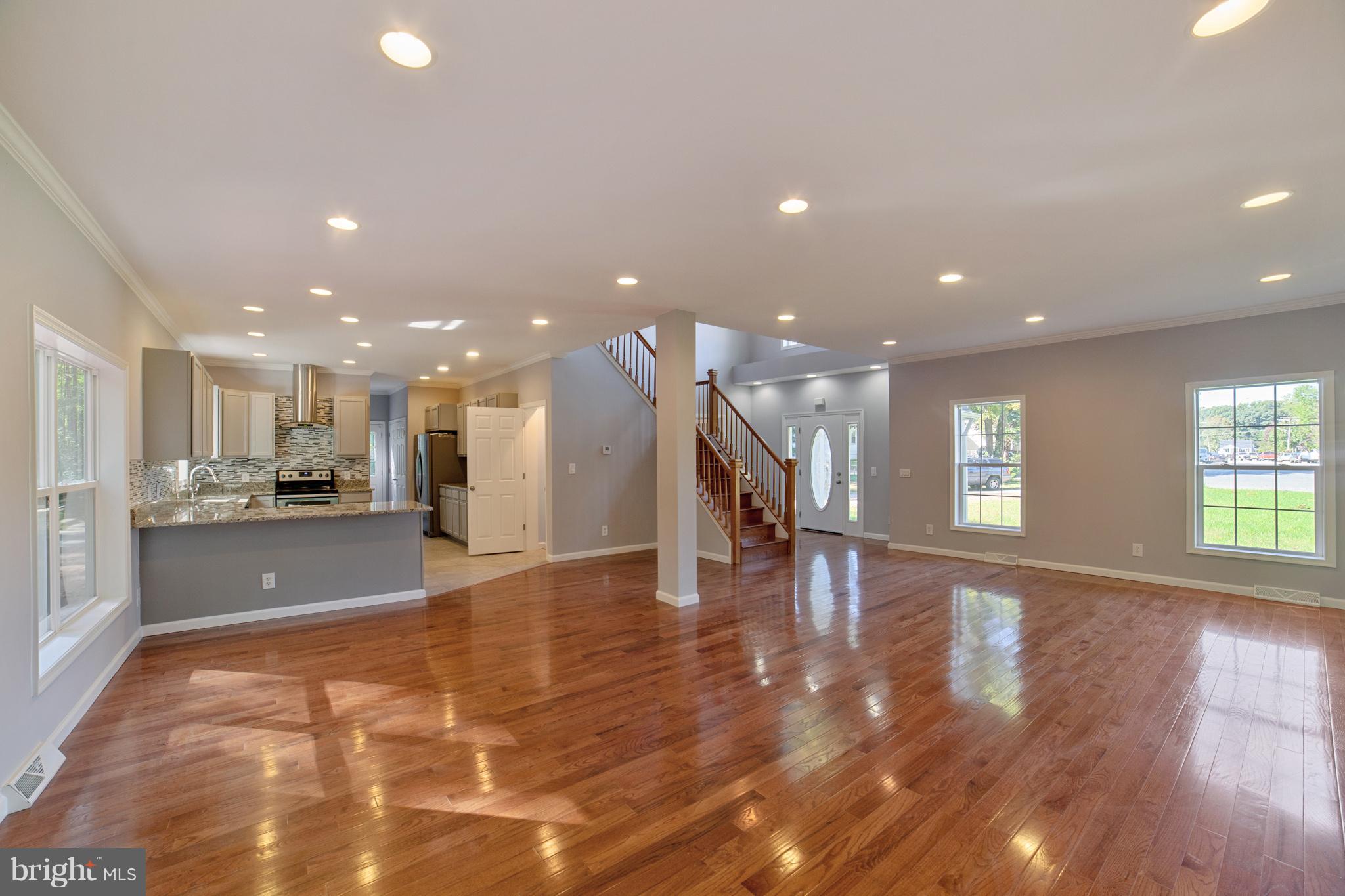 320 W Road Baltimore, MD 21221 - Photo 3 of 30 a view of an empty room with wooden floor and a kitchen