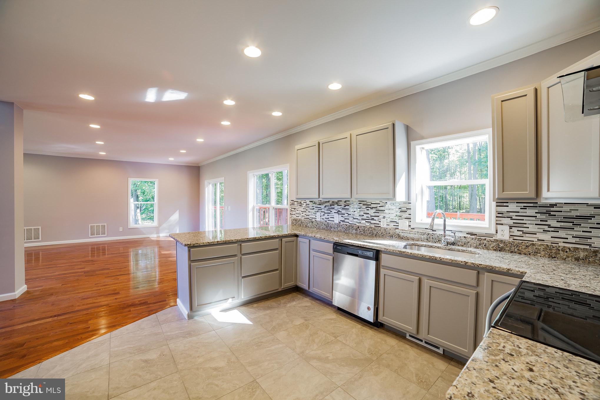 320 W Road Baltimore, MD 21221 - Photo 5 of 30 a large kitchen with stainless steel appliances granite countertop a sink and cabinets