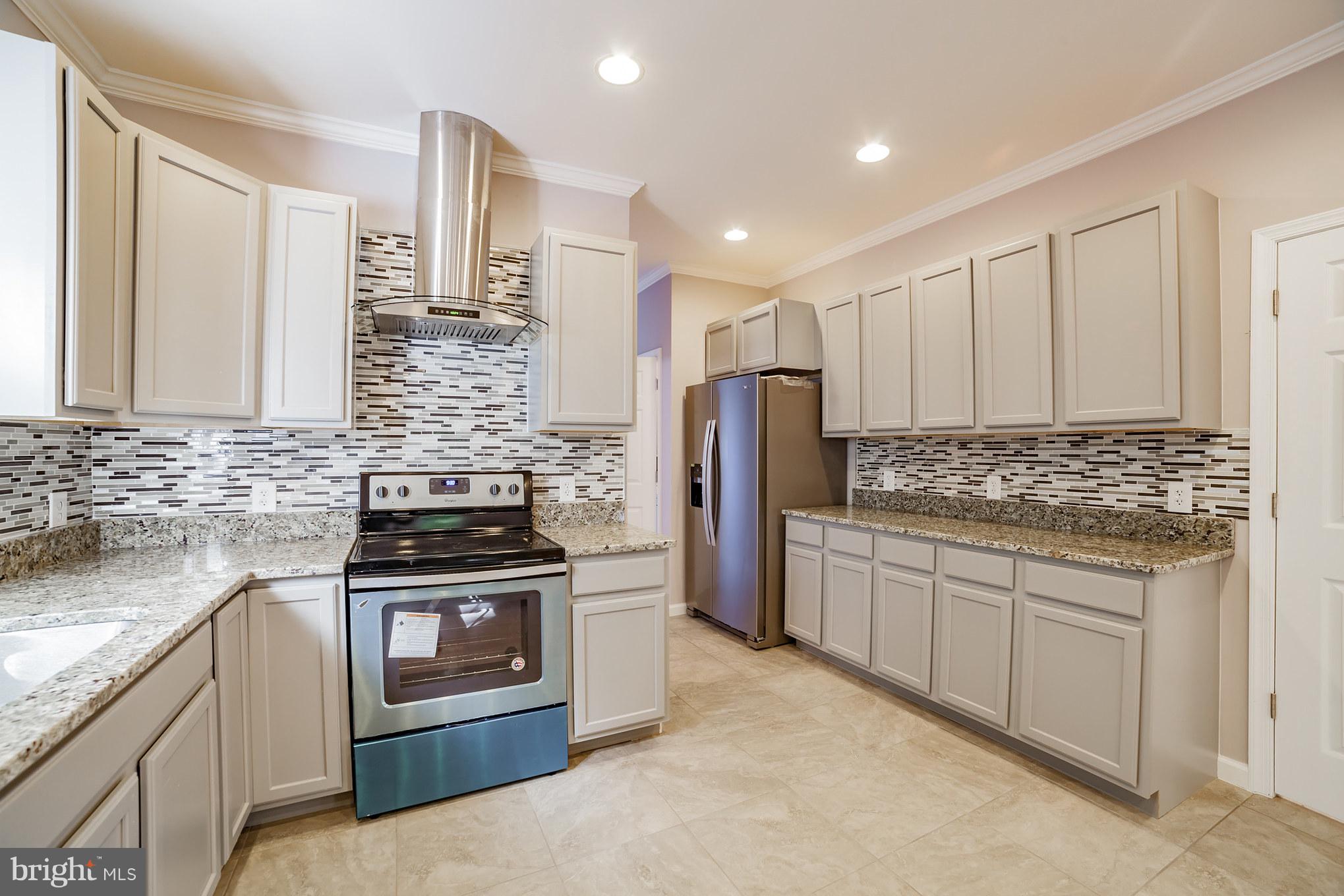 320 W Road Baltimore, MD 21221 - Photo 6 of 30 a kitchen with stainless steel appliances granite countertop a stove a sink and a refrigerator