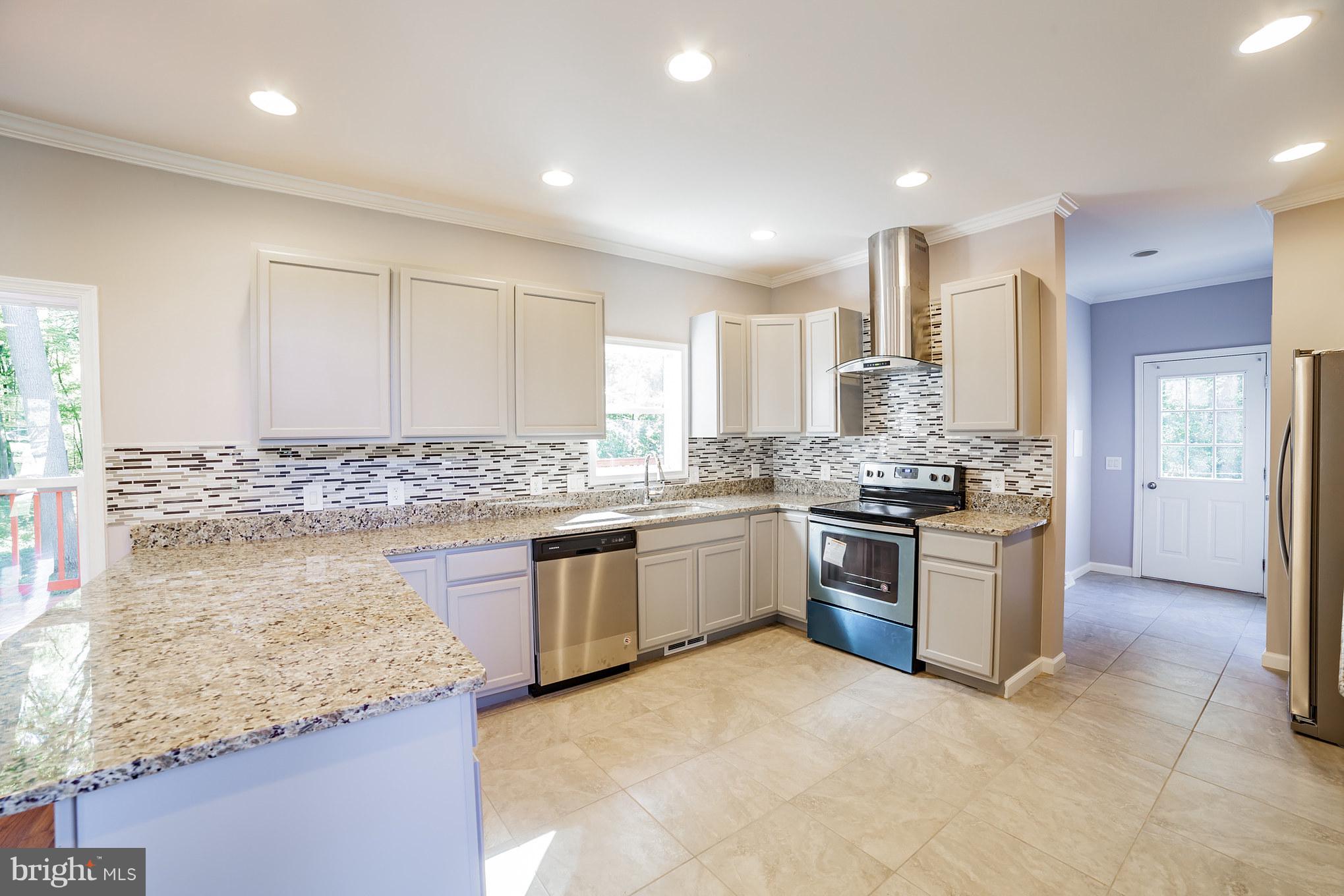 320 W Road Baltimore, MD 21221 - Photo 7 of 30 a kitchen with a sink stove and white cabinets