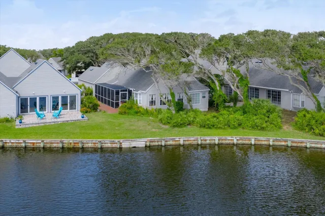 a view of a balcony with wooden chairs