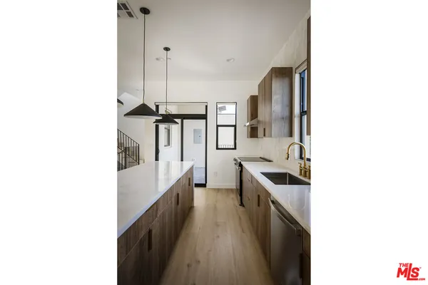 a kitchen with stainless steel appliances a sink and stove