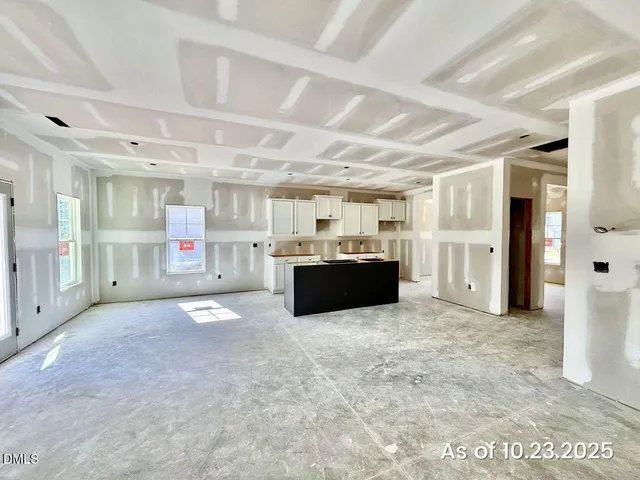 a large room with stainless steel appliances kitchen island granite countertop a large kitchen view and a window