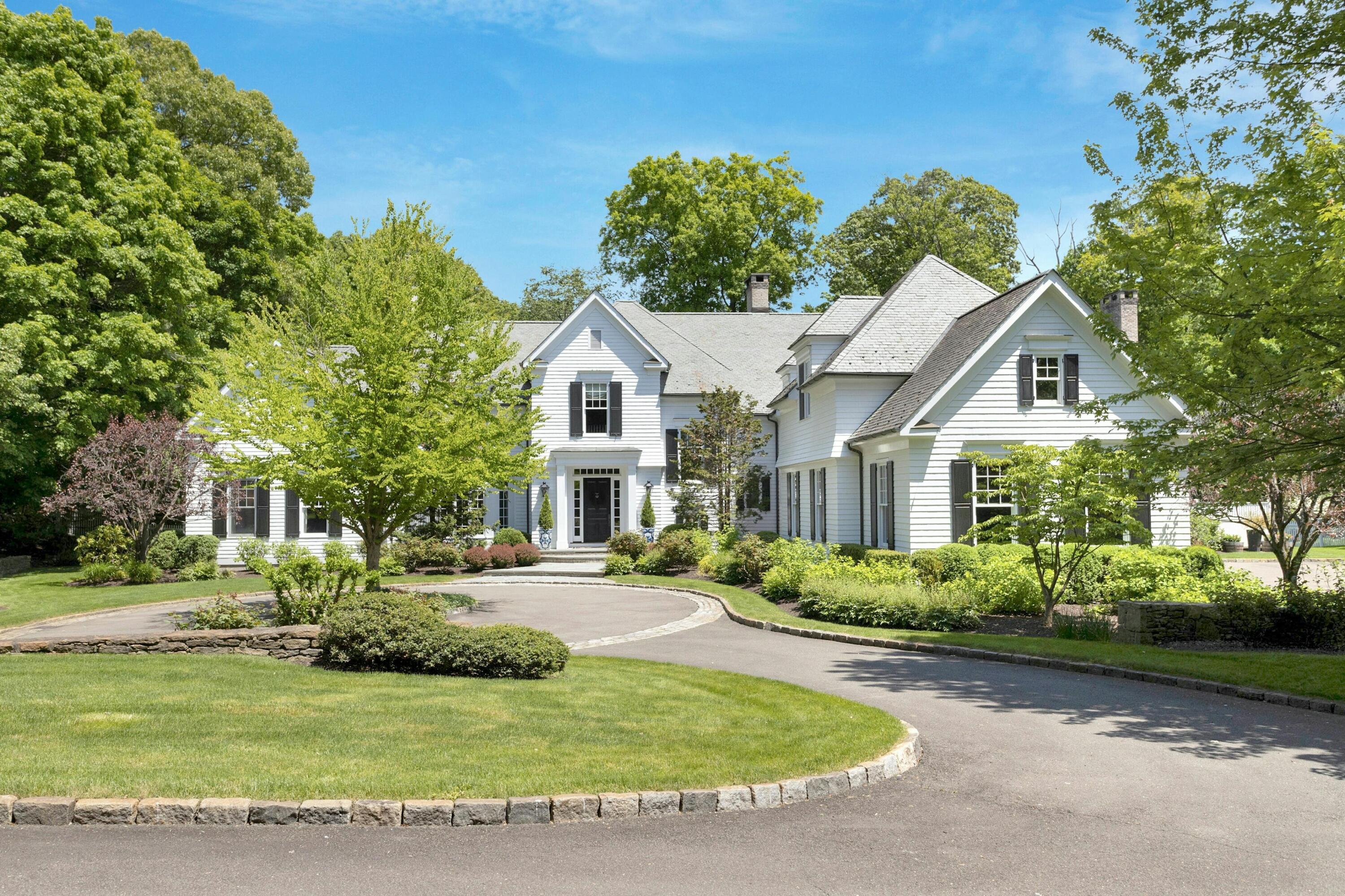 378 Brookside Road Darien, CT 06820 - Photo 2 of 40 a front view of a house with a garden