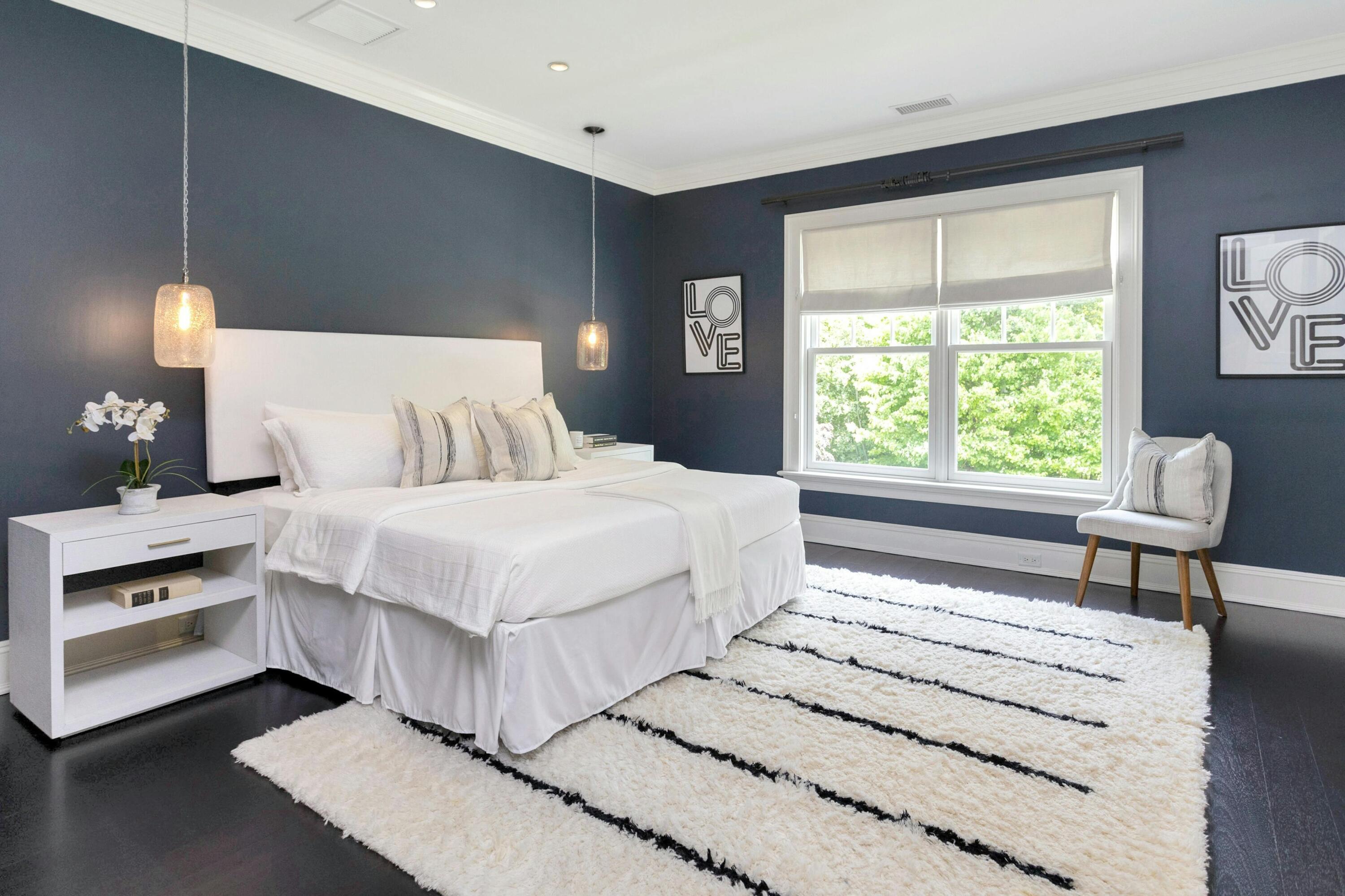 378 Brookside Road Darien, CT 06820 - Photo 27 of 40 a bedroom with a bed and a lamp on table