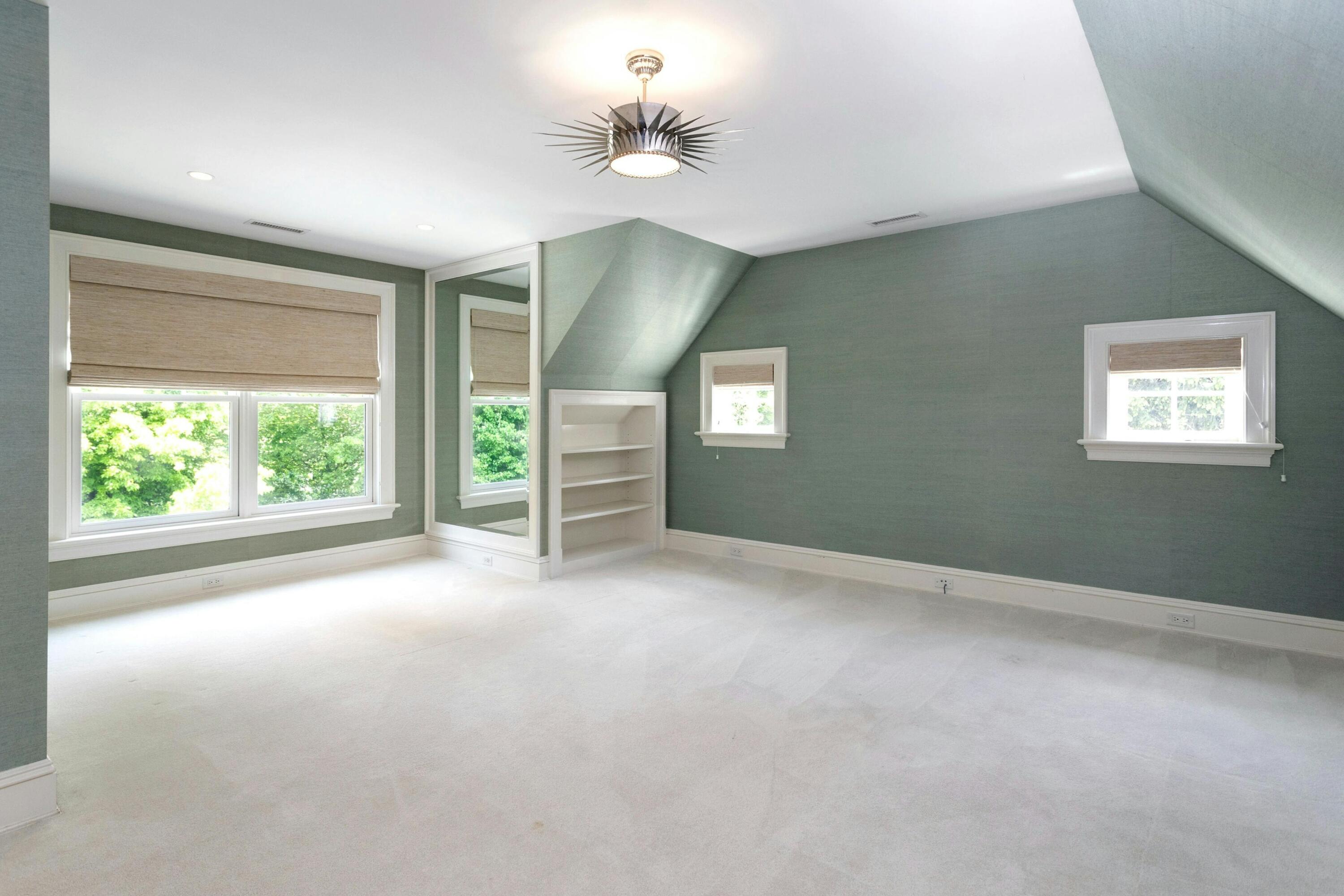 378 Brookside Road Darien, CT 06820 - Photo 29 of 40 an empty room with windows and ceiling fan