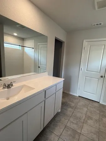a bathroom with a shower and a room