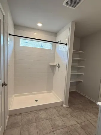 an empty room with windows and closet