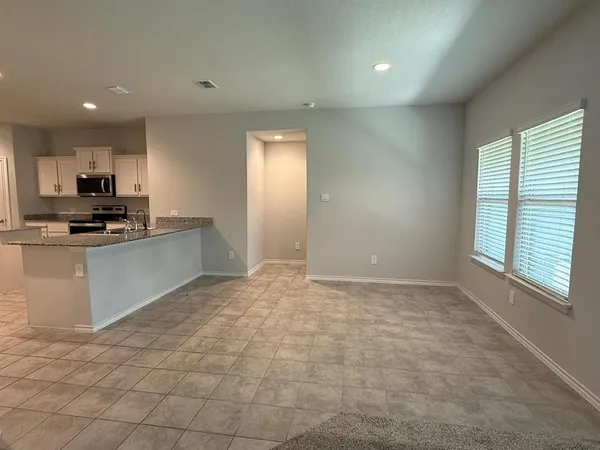 an empty room with white walls and tiles