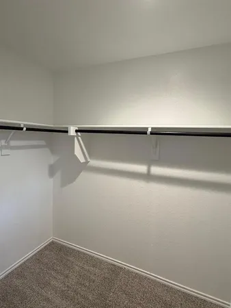 an empty room with wooden floor and door