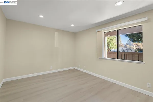 a view of a house with a big yard plants and large trees