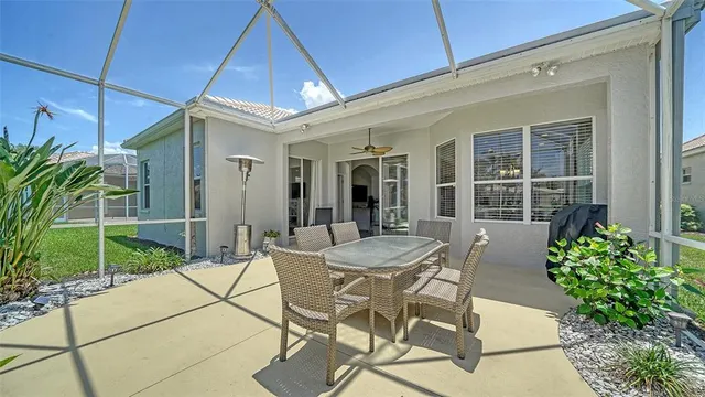 a view of a house with backyard porch and sitting area