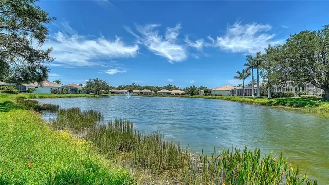 a view of a house with swimming pool and sitting area