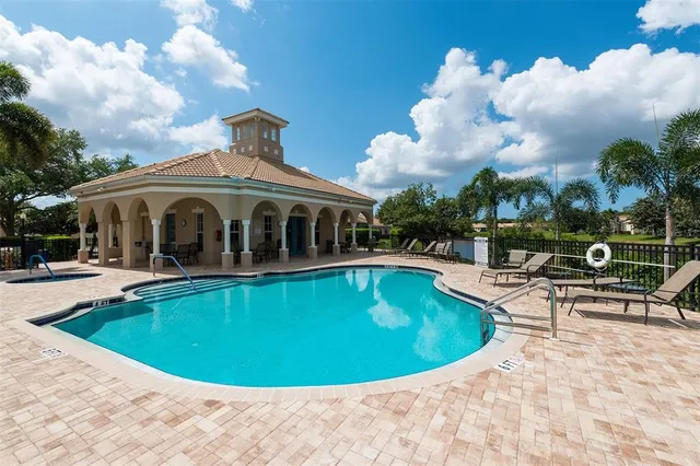 swimming pool view with a seating space