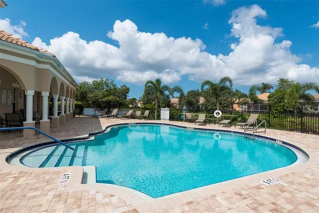 a living room with fireplace furniture and a large window