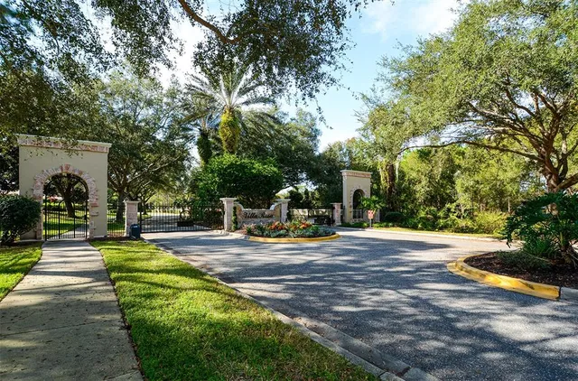 a front view of a house with a garden and trees