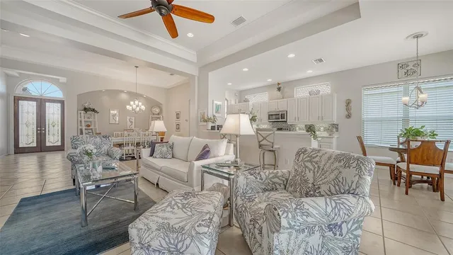 a living room with lots of furniture and a chandelier