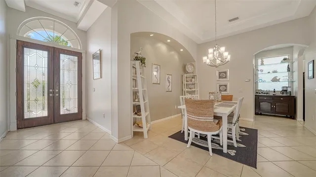 a view of a dining room with furniture and chandelier