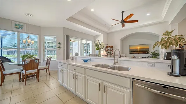 a kitchen with a sink and living room view