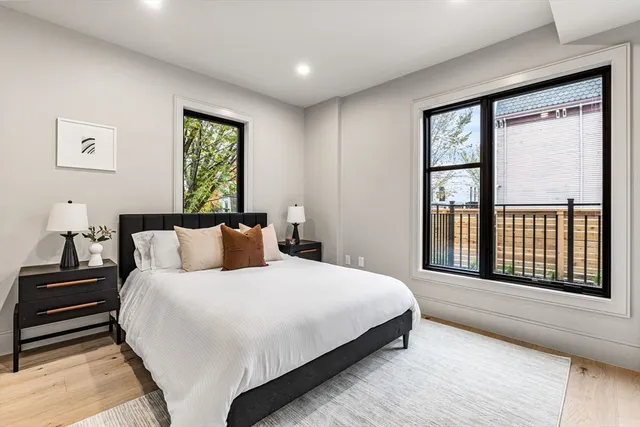 a bedroom with a large bed and a large window