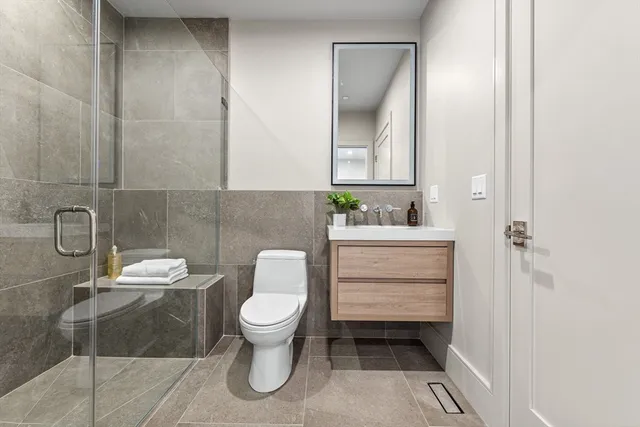 a bathroom with a sink toilet and mirror