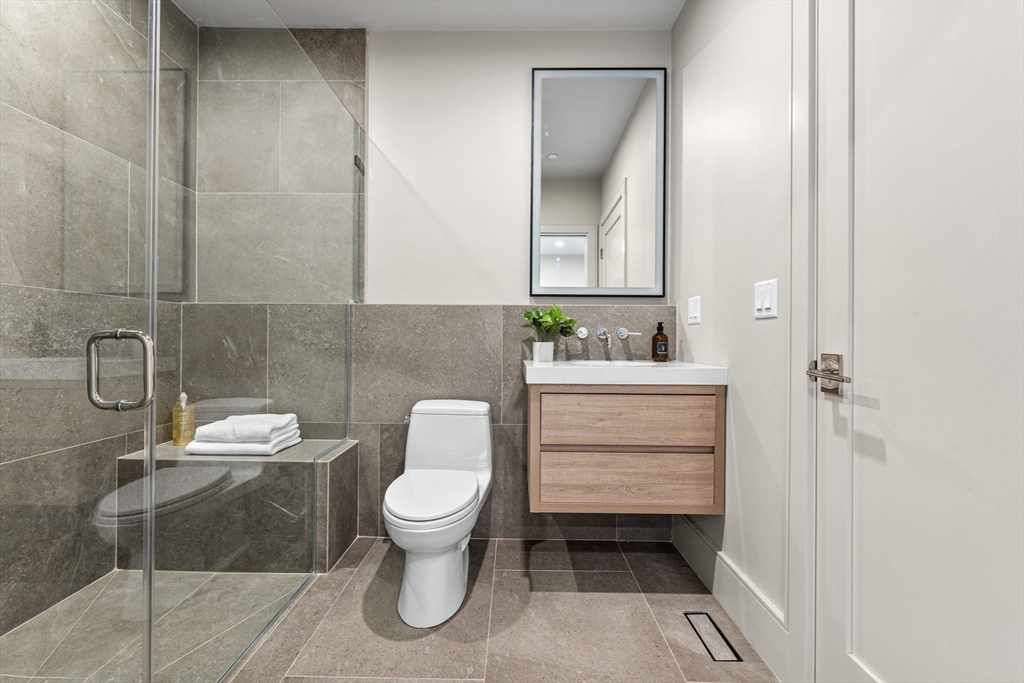 300 Franklin Street, Unit 1 Cambridge, MA 02139 - Photo 15 of 38 a bathroom with a sink toilet and mirror