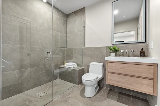 a bathroom with a toilet sink and vanity