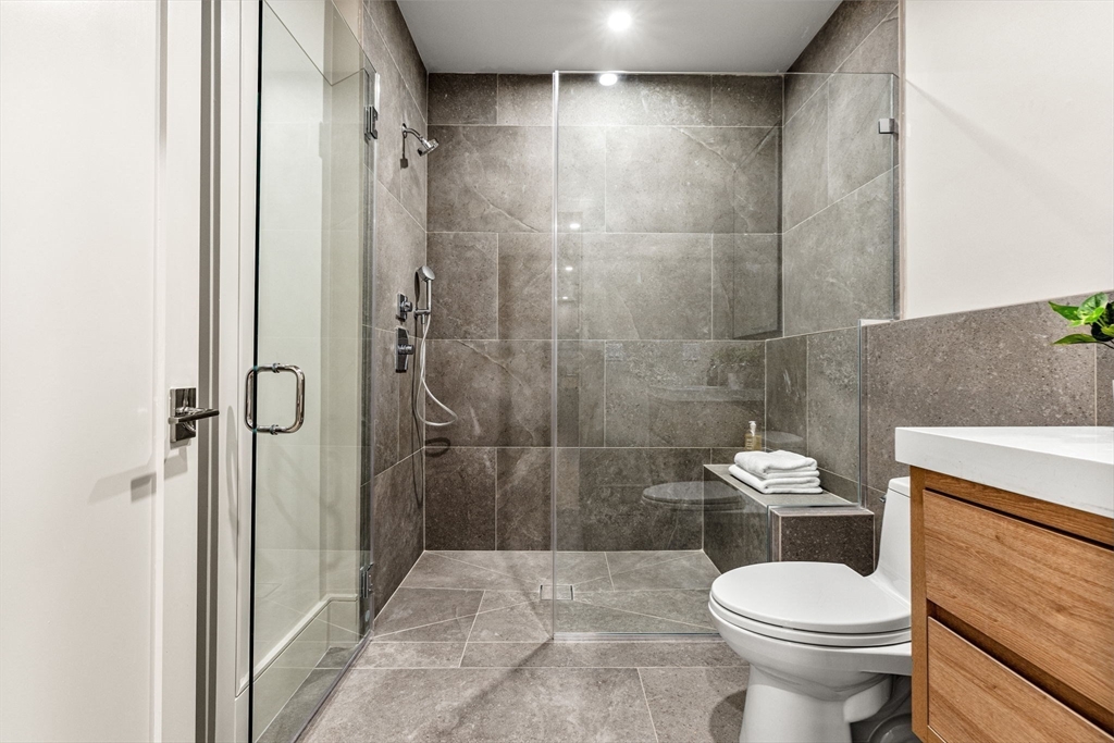 300 Franklin Street, Unit 1 Cambridge, MA 02139 - Photo 18 of 38 a white toilet sitting next to a bathroom sink and a shower