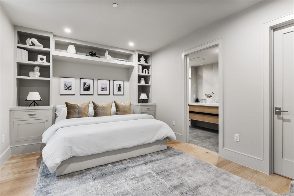 300 Franklin Street, Unit 1 Cambridge, MA 02139 - Photo 23 of 38 a spacious bedroom with a bed and a cabinets