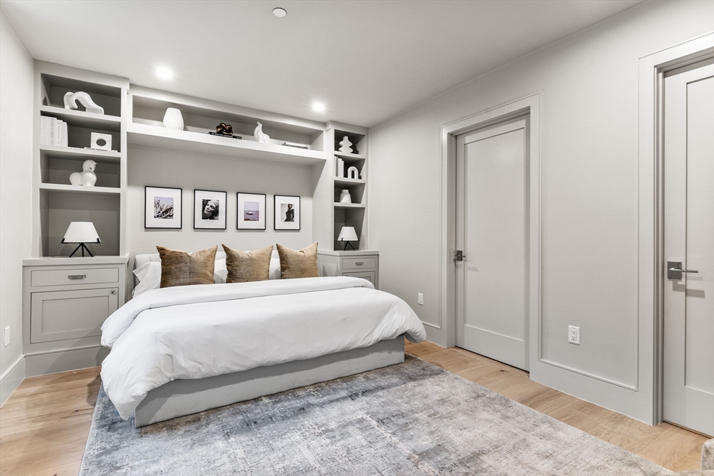 300 Franklin Street, Unit 1 Cambridge, MA 02139 - Photo 24 of 38 a bedroom with a large bed and a book shelf