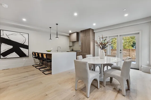 a dining room with furniture and a floor to ceiling window