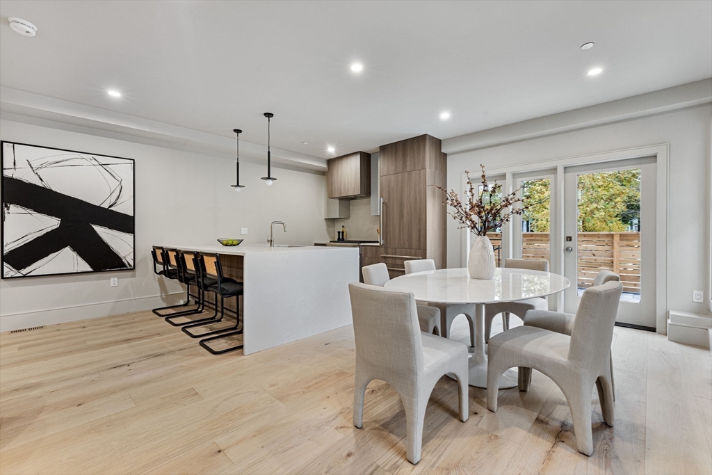 300 Franklin Street, Unit 1 Cambridge, MA 02139 - Photo 6 of 38 a dining room with furniture and a floor to ceiling window