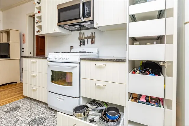 a kitchen with a sink appliances and cabinets