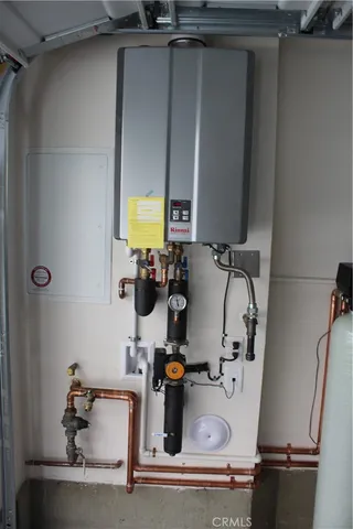 a view of a room with water heater and white walls