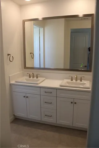 a bathroom with a sink double vanity and a mirror