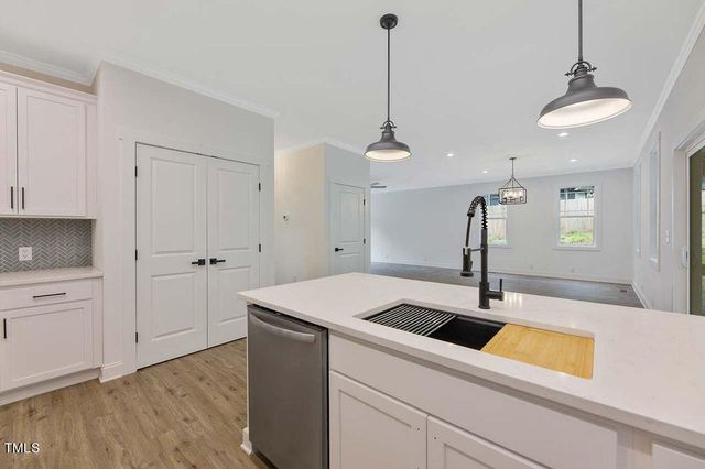 a kitchen with a sink and chandelier
