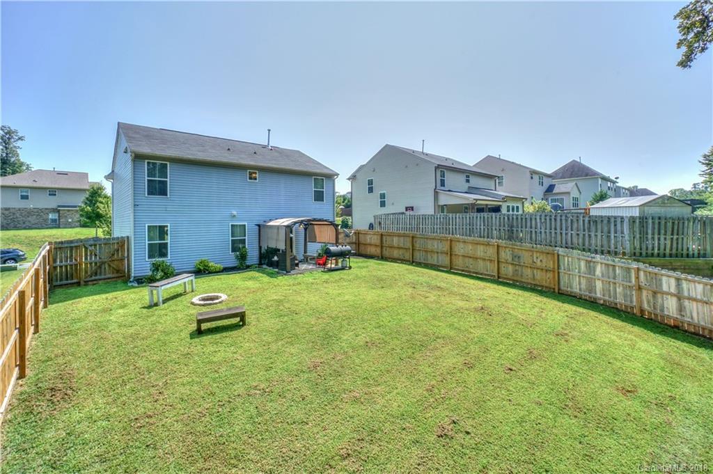 7550 West Berkeley Road, Unit 22 Denver, NC 28037 - Photo 16 of 20 a view of a backyard with a table and chairs